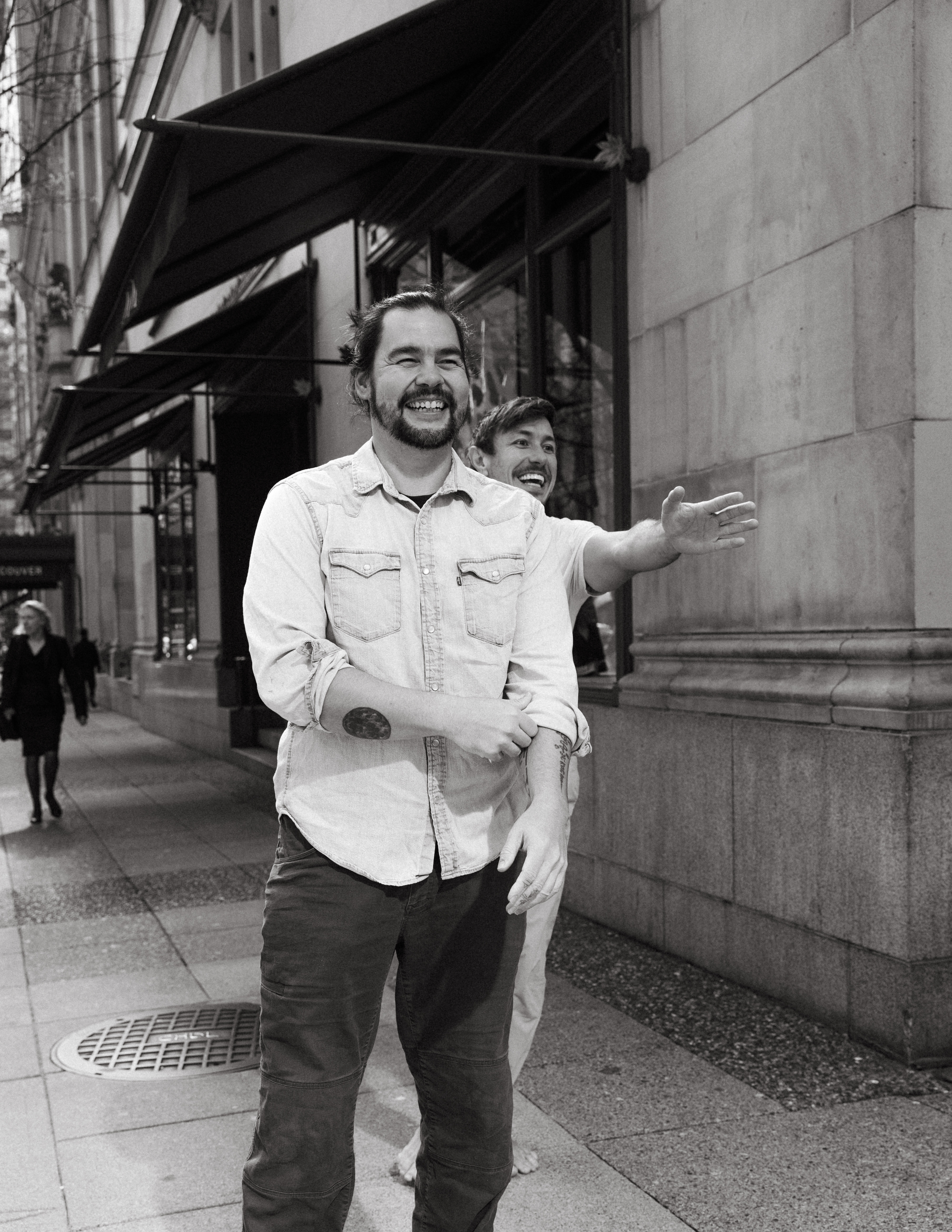 Candid black-and-white street portrait of Devon smiling