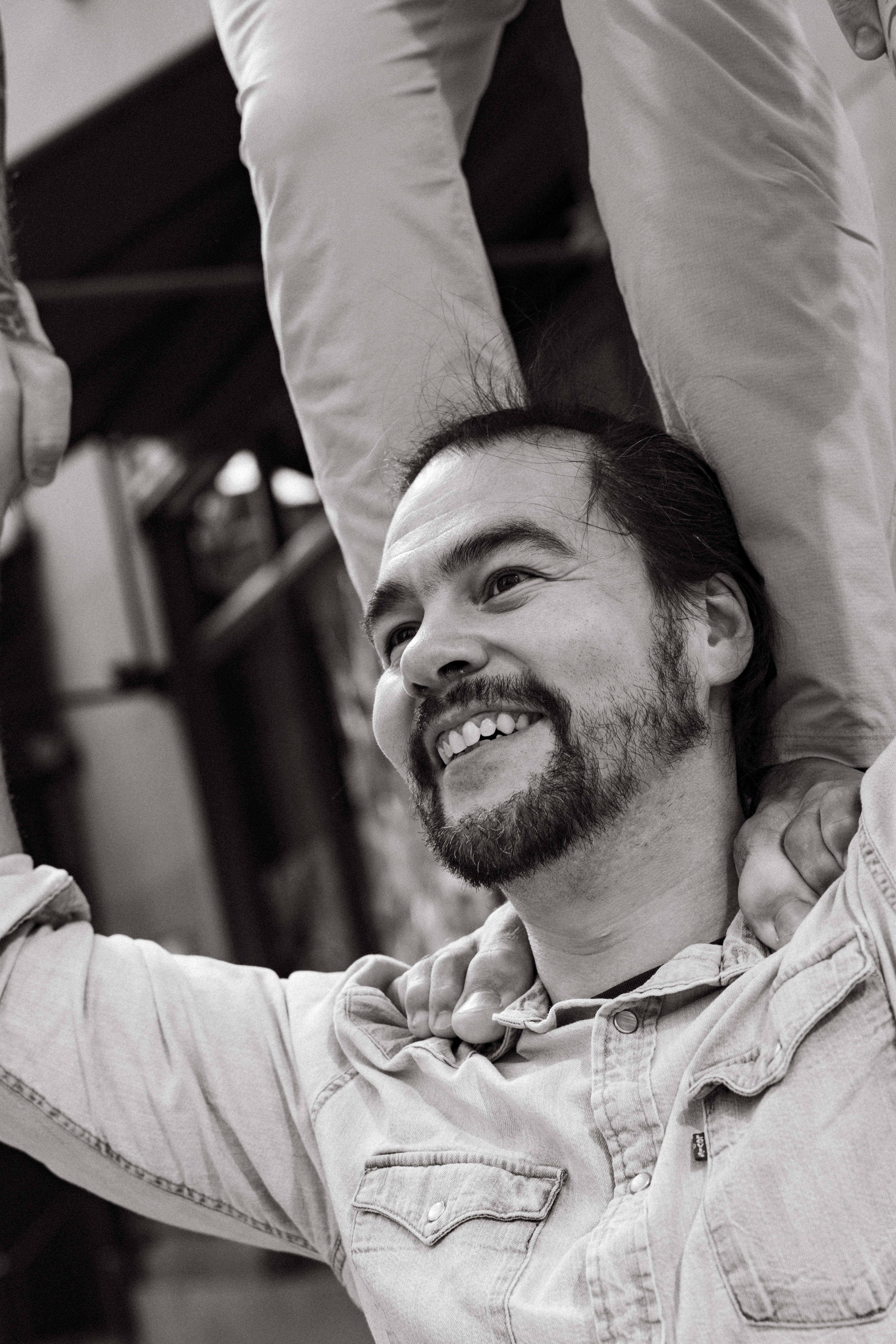 Close-up black-and-white portrait of Devon smiling